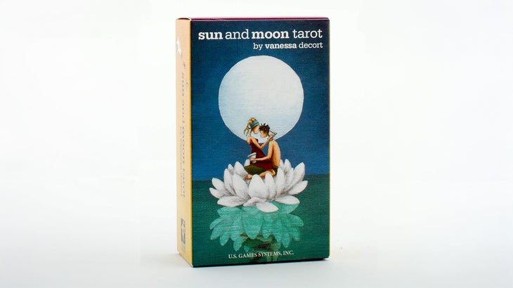 box of tarot cards with a couple embracing on a lotus flower under the moon