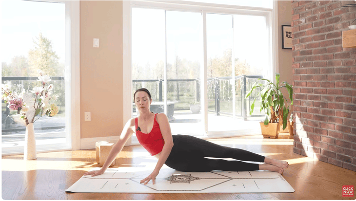 Woman lying on her right side on a yoga mat