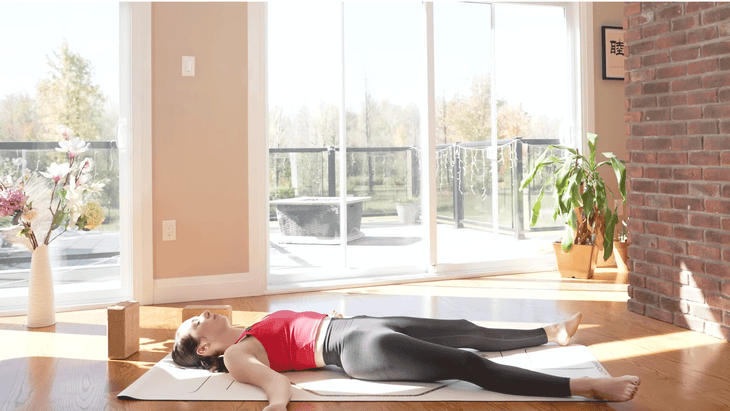 Woman lying on Savasana