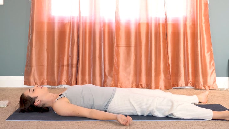 woman practicing yin yoga and setting intentions on a yoga mat