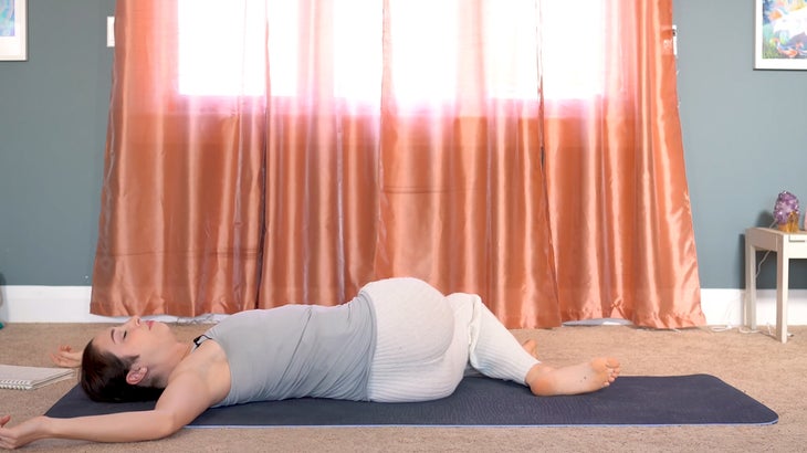 woman practicing yin yoga and setting intentions on a yoga mat