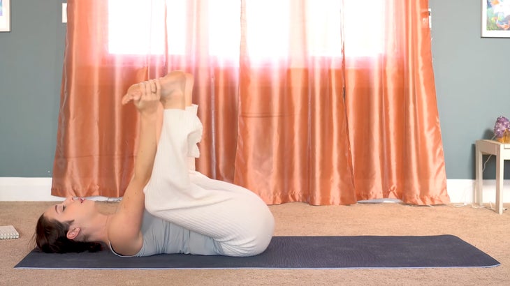 woman practicing yin yoga and setting intentions on a yoga mat