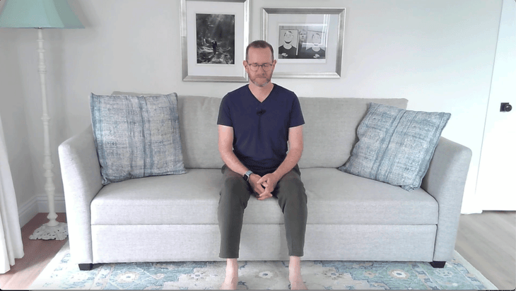 Man sitting on a couch in meditation