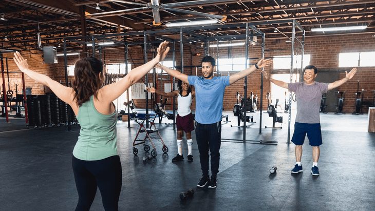 Class at a gym practicing arm circles