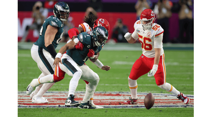 Quarterback Jalen Hurts of the Philadelphia Eagles fumbles the football while being tackled by the Kansas City Chiefs