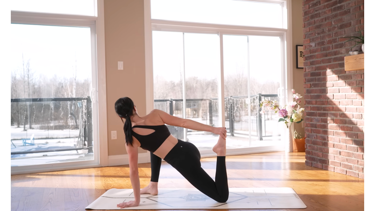 Woman kneeling on a yoga mat