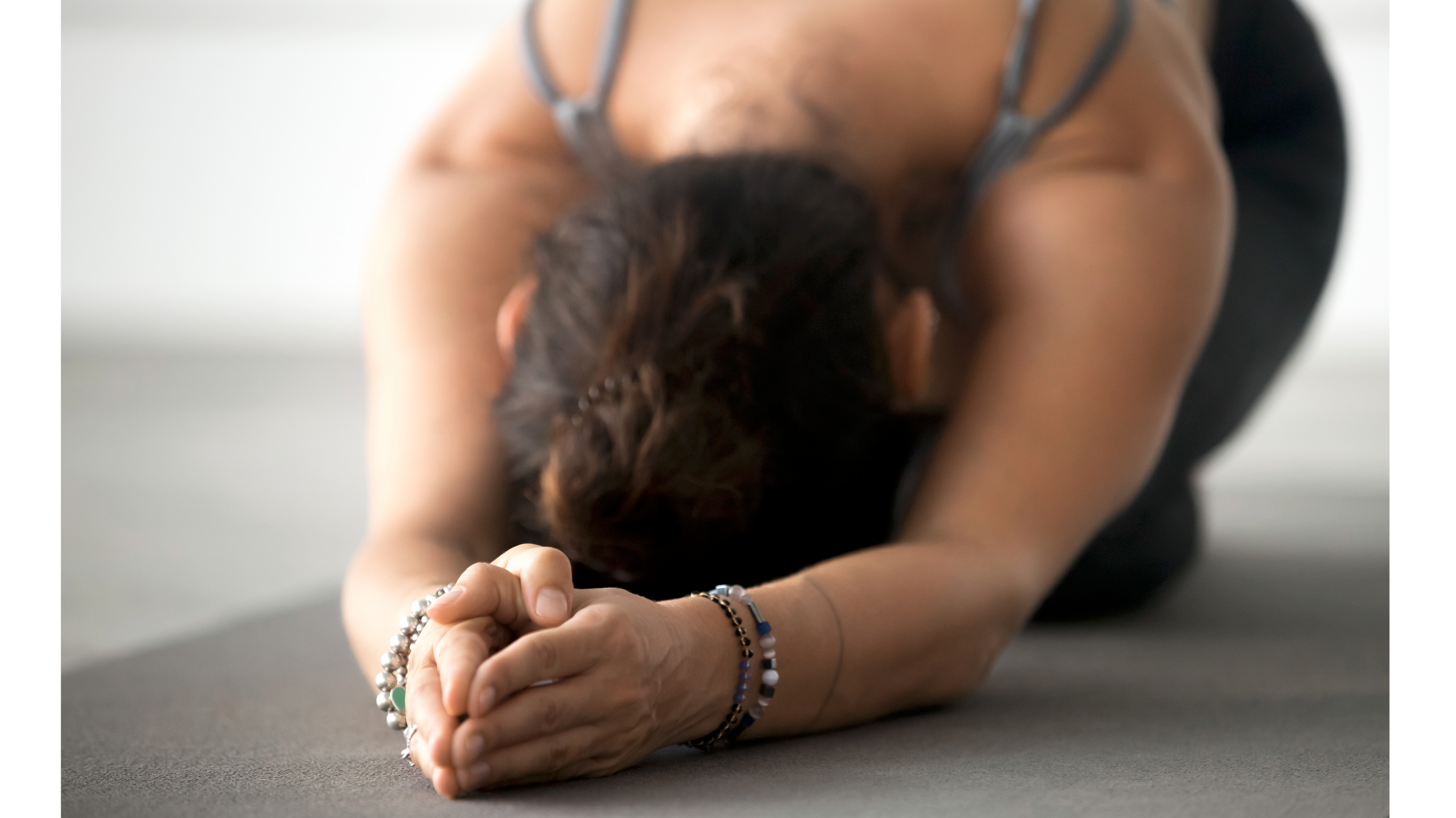Woman on a yoga mat in Child's Pose