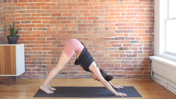 Woman on a yoga mat in Downward-Facing Dog