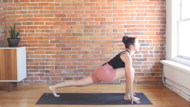 Woman in runner's lunge on a yoga mat