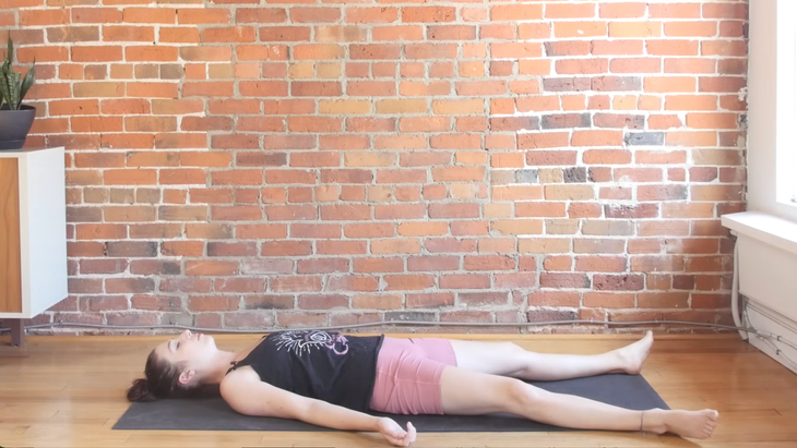 Woman on a yoga mat in Savasana