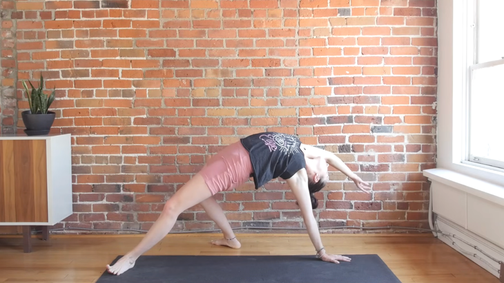 Woman in Wild Thing on a yoga mat