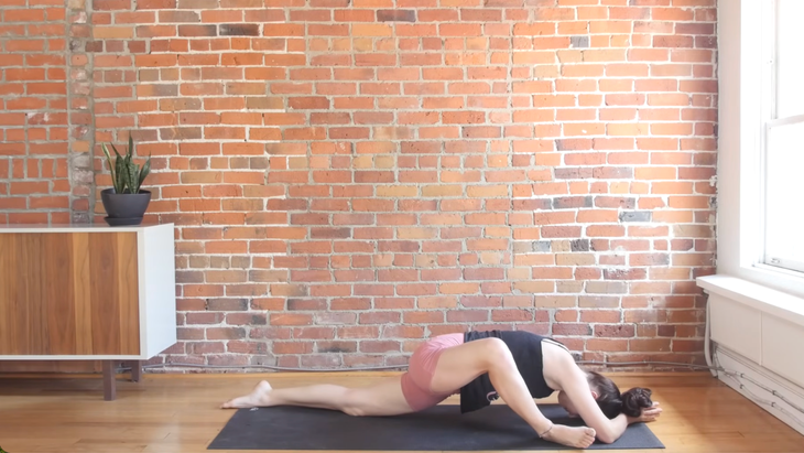 Woman in Lizard Pose on a yoga mat