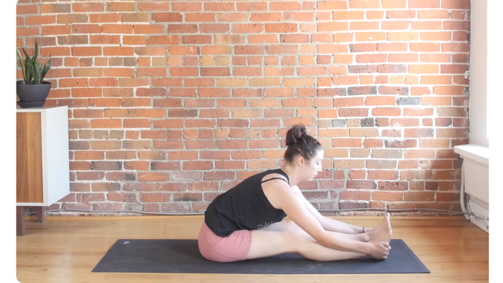 Woman in a seated forward bend