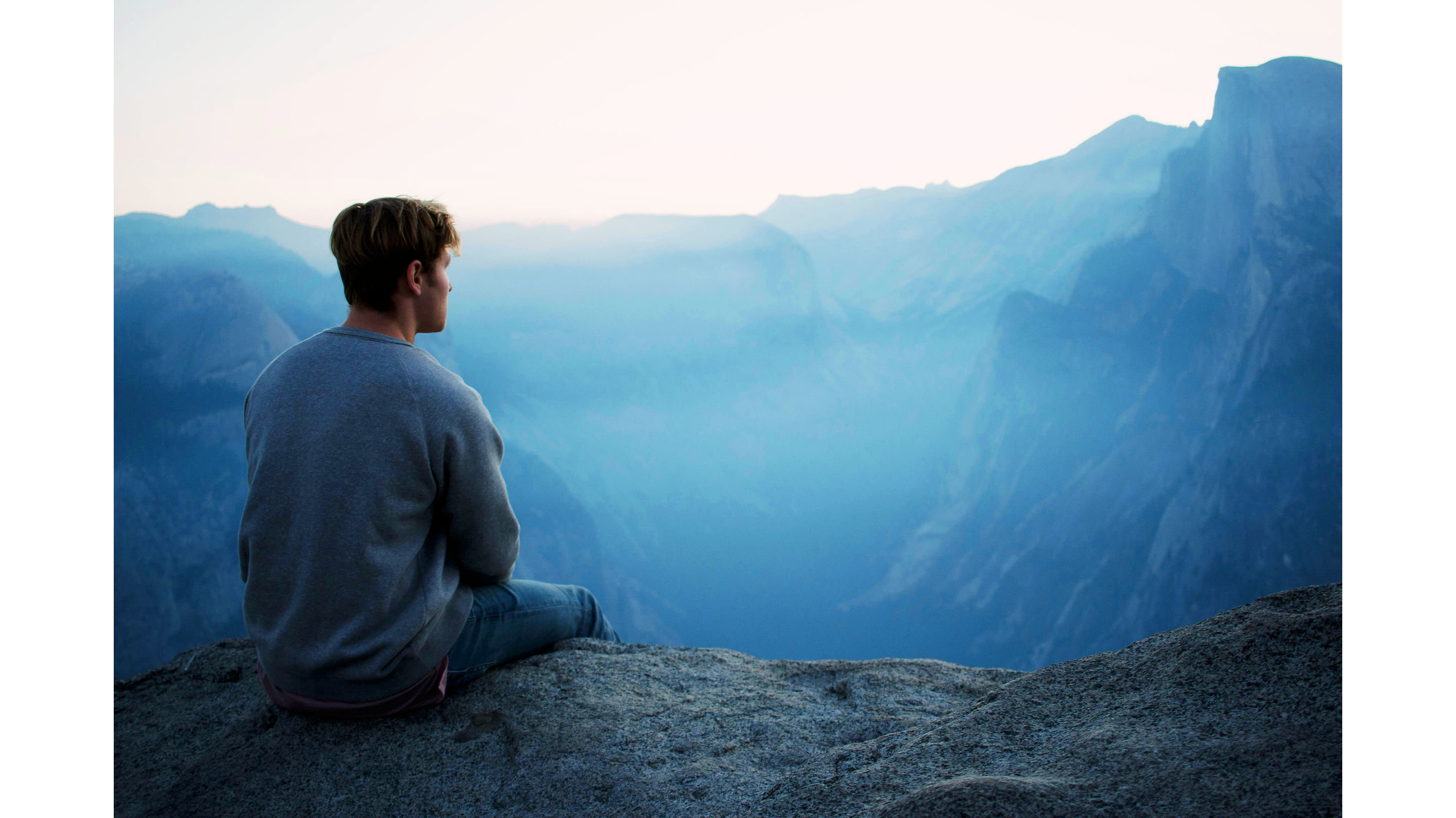 Man sitting during a hike and meditating