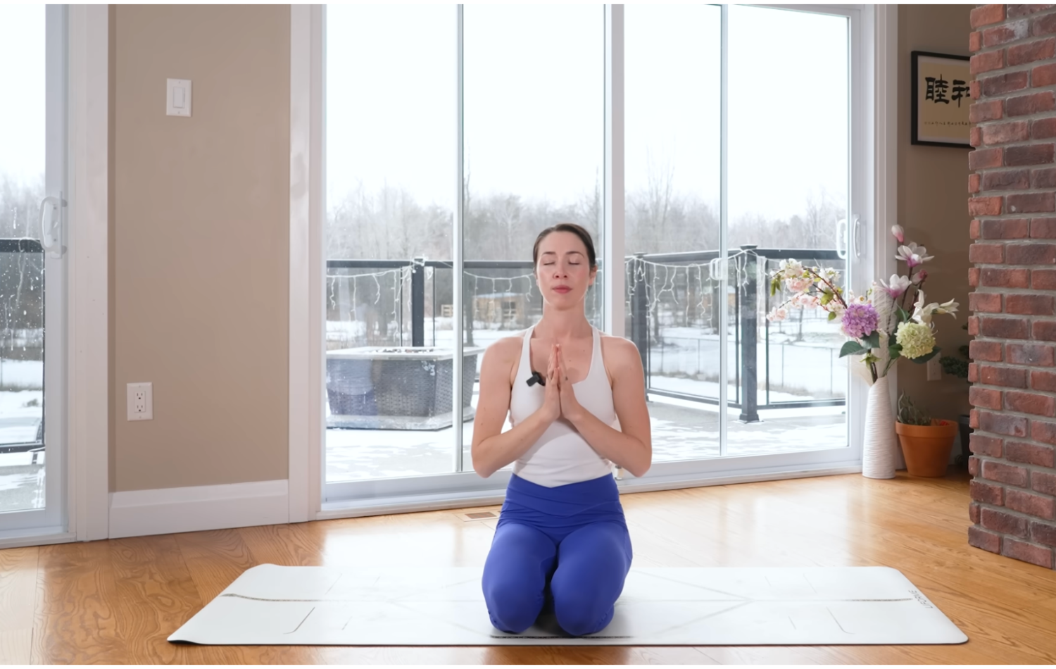 Woman kneeling on a yoga mat