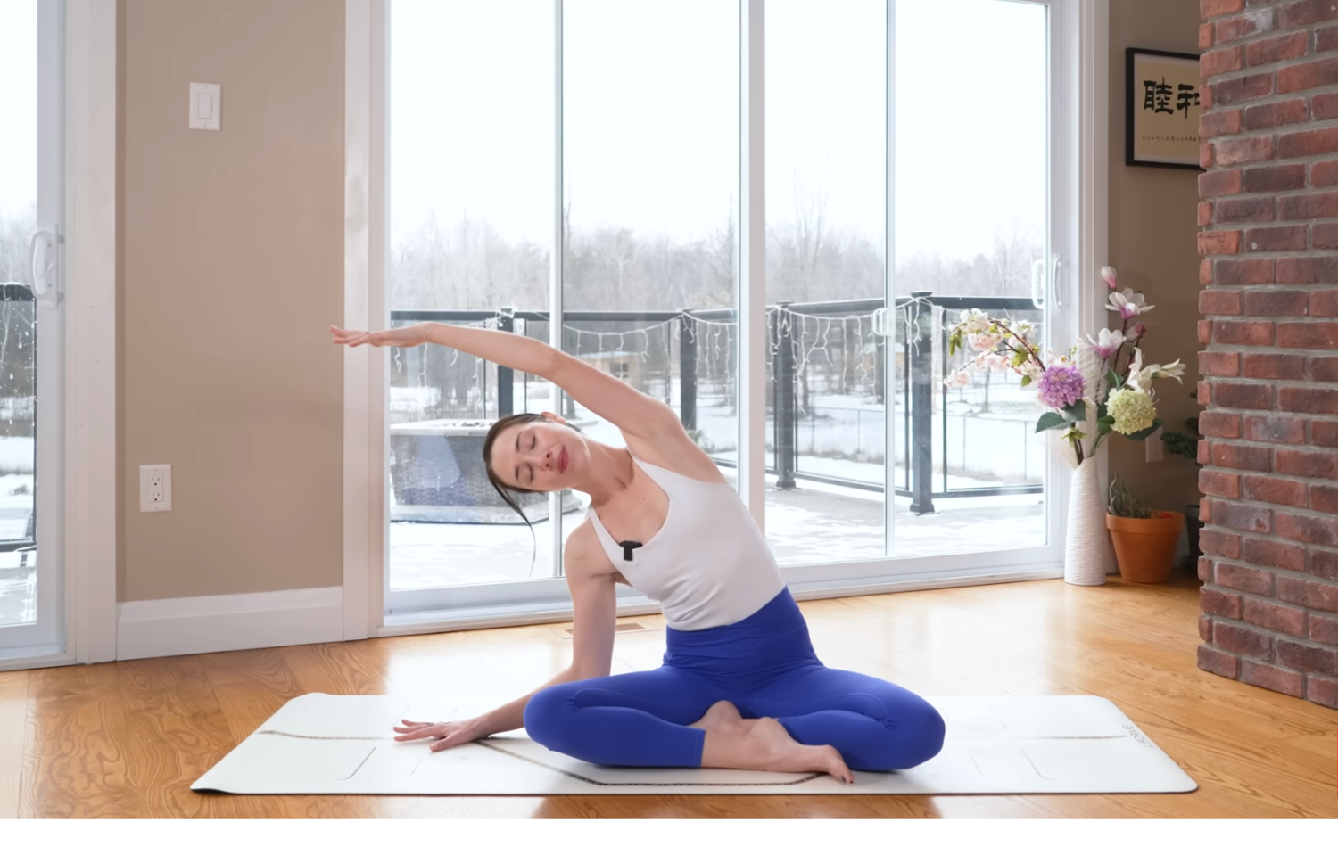 Woman sitting cross-legged while doing a side stretch