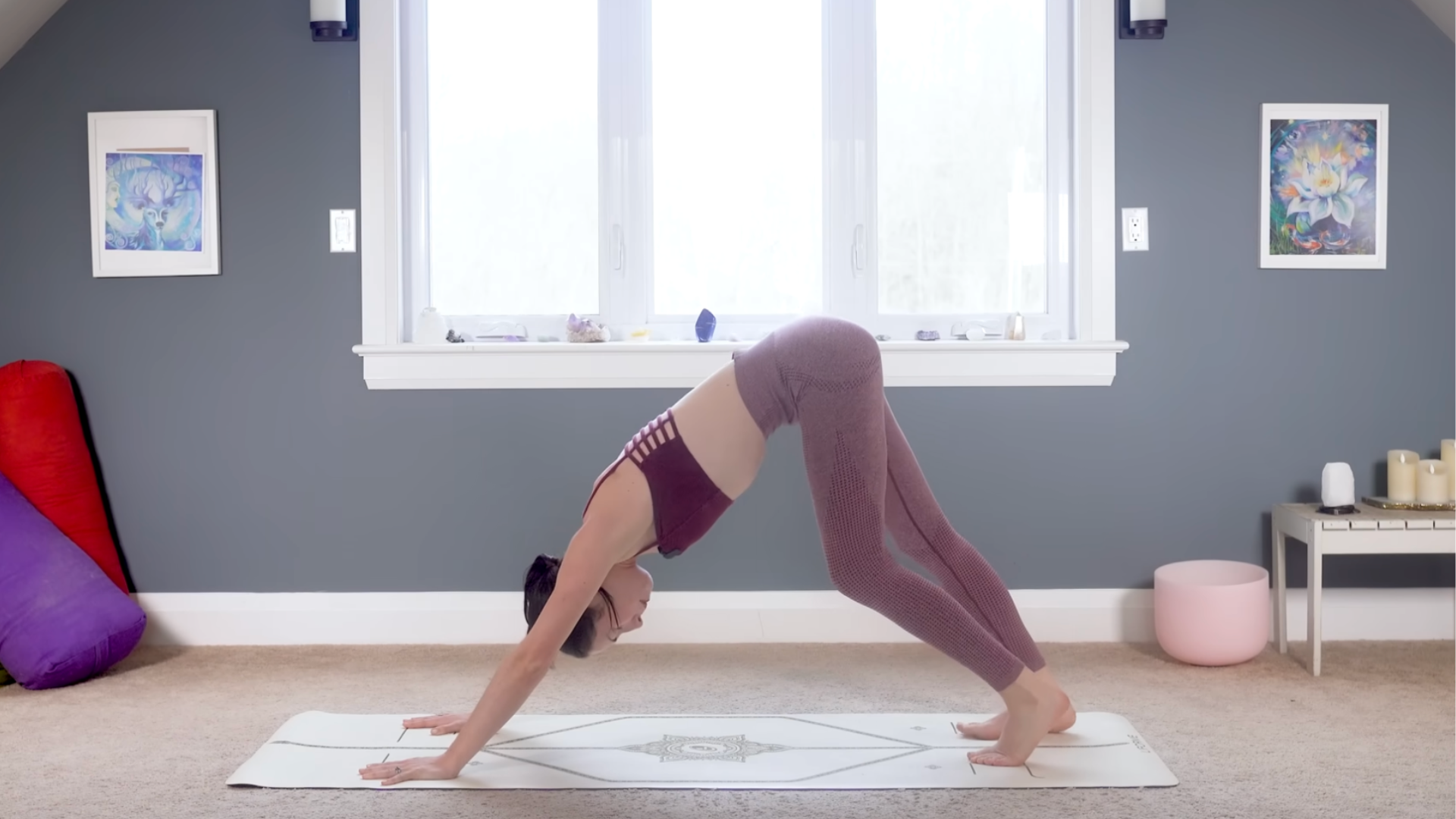 Woman in Downward-Facing Dog on a yoga mat