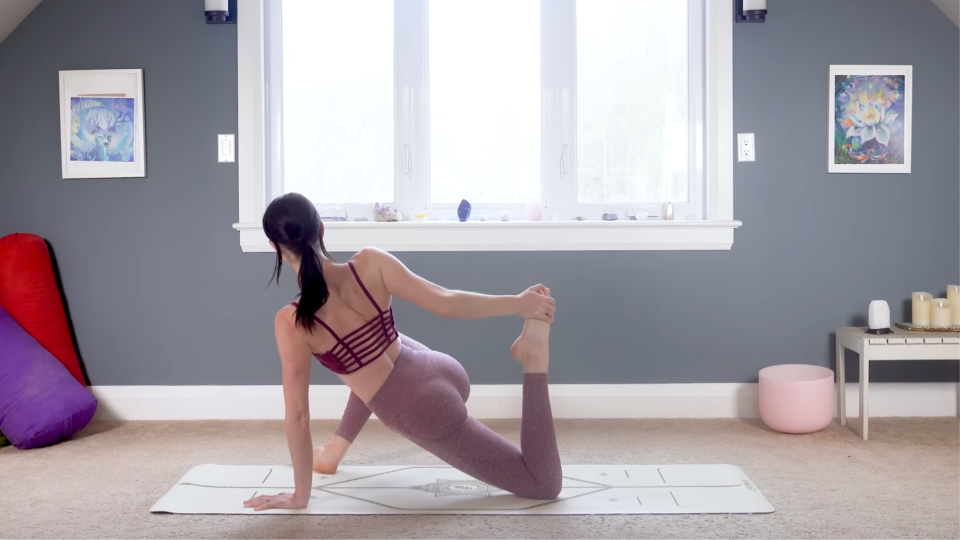 Woman in a low lunge while reaching back and holding onto her back foot