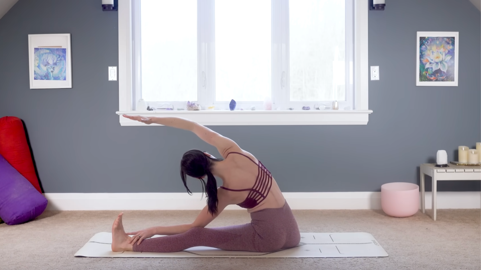 Woman sitting on a mat leaning to the side