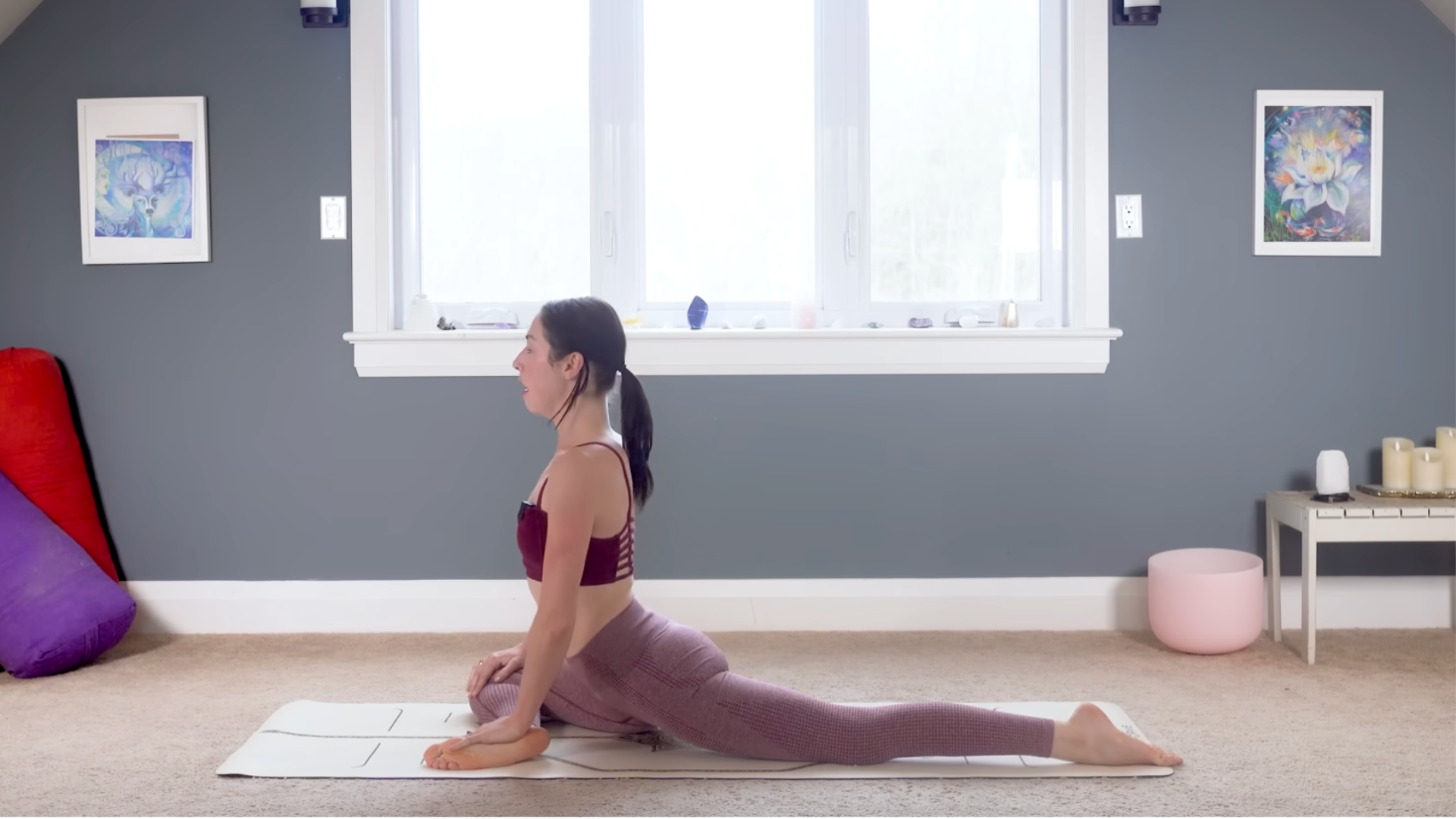 Woman practicing 15-minute yoga in Pigeon Pose on a yoga mat