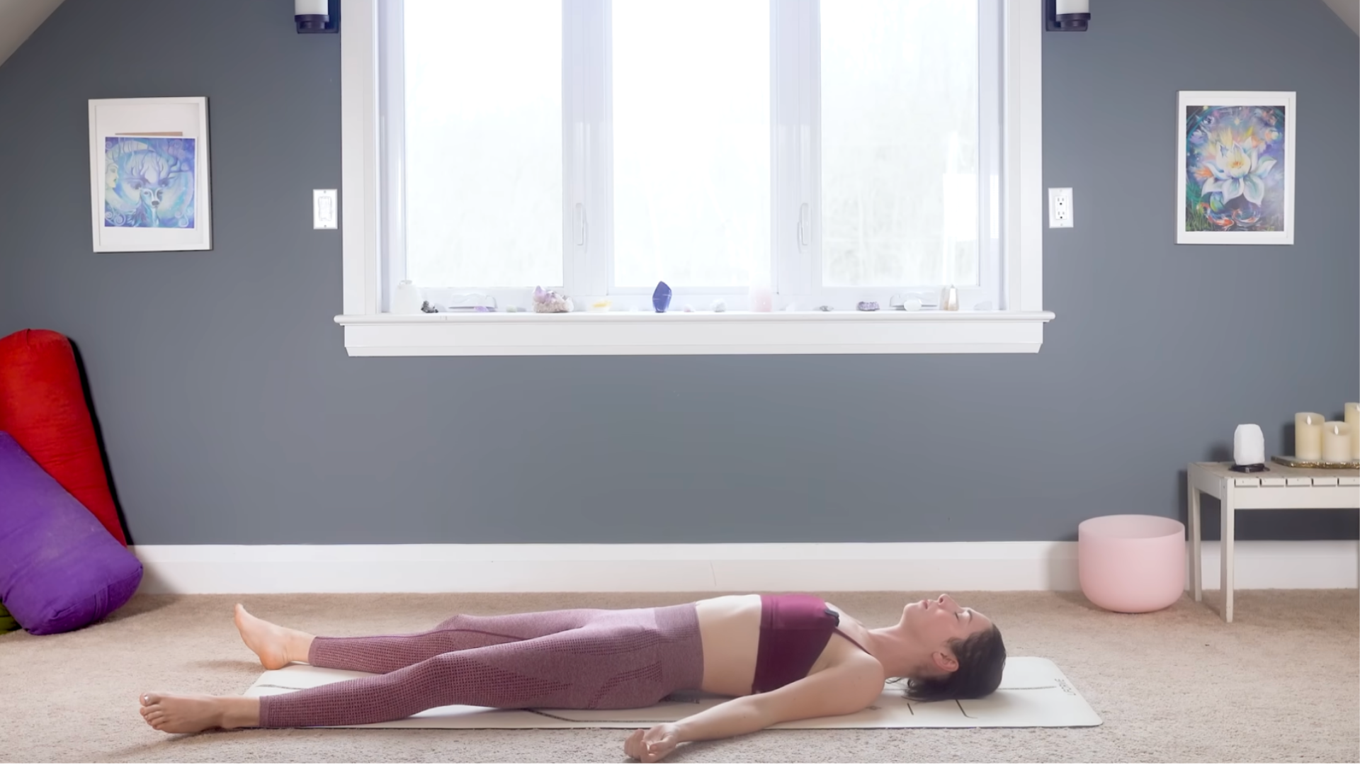 Woman lying on a yoga mat in Savasana