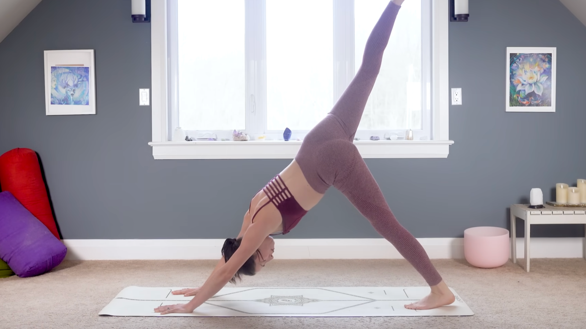 Woman in three-legged dog on a yoga mat
