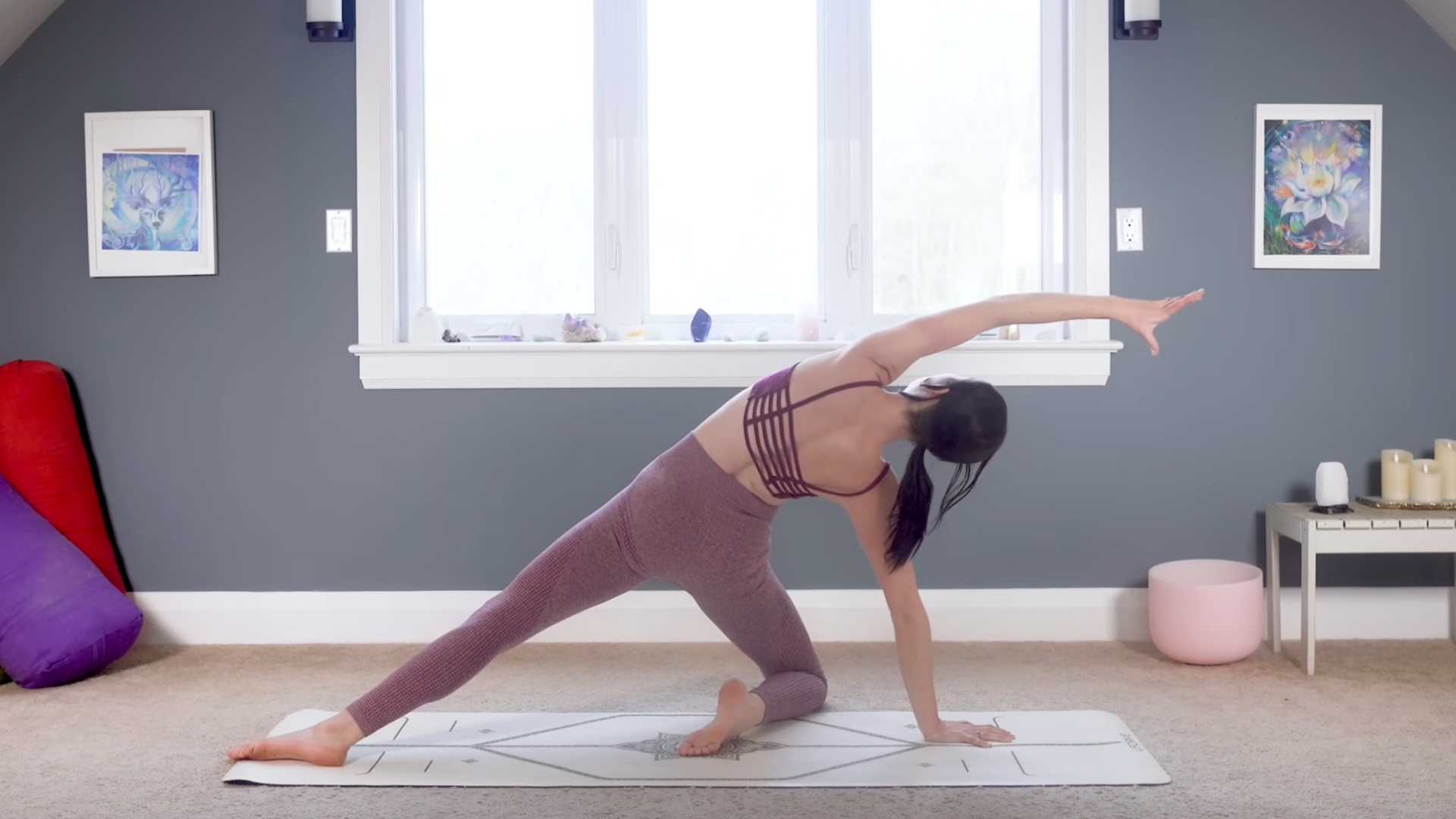 Woman kneeling on a yoga mat during a 15-minute yoga practice in a kneeling Wild Thing