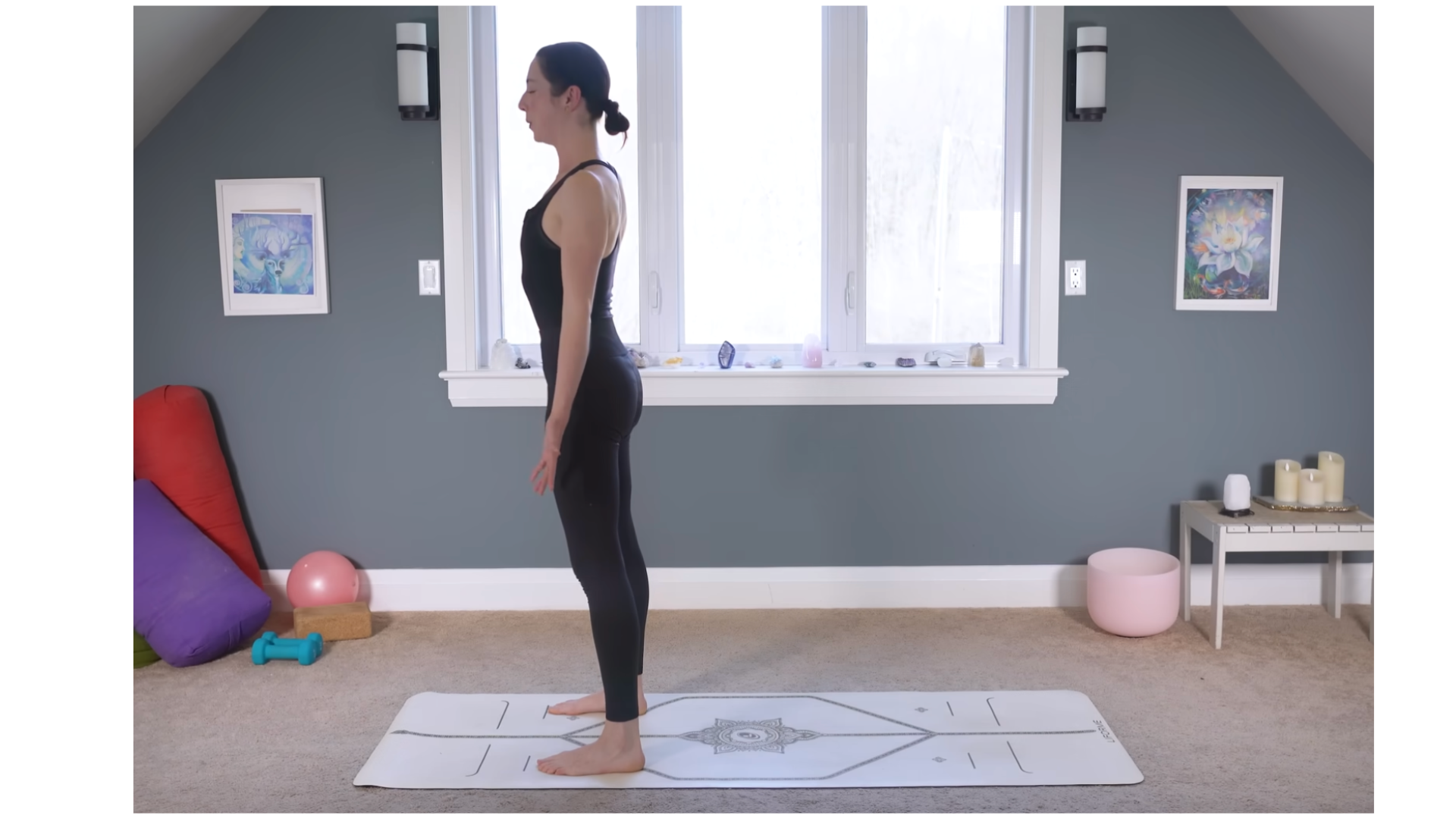 Yoga teacher on a mat standing in Mountain Pose