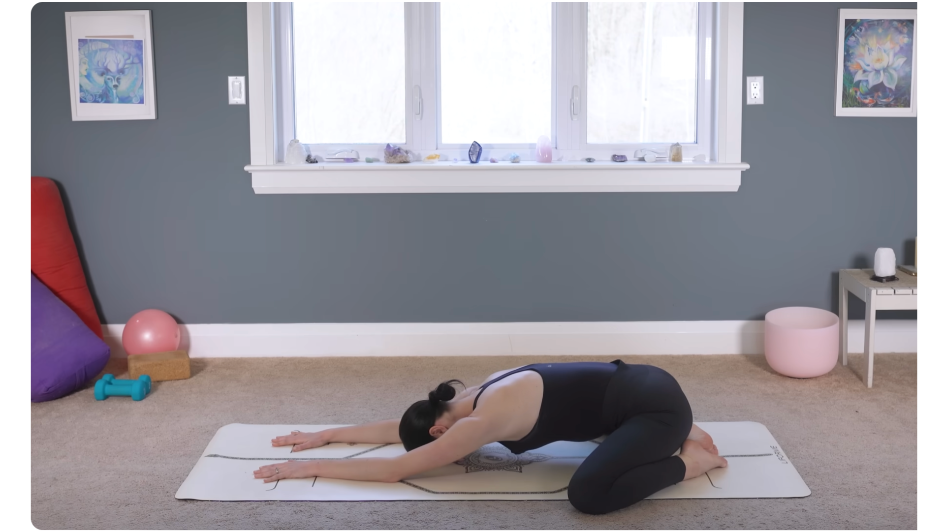 Yoga teacher on a mat in Child's Pose during a 10-minute morning yoga routine
