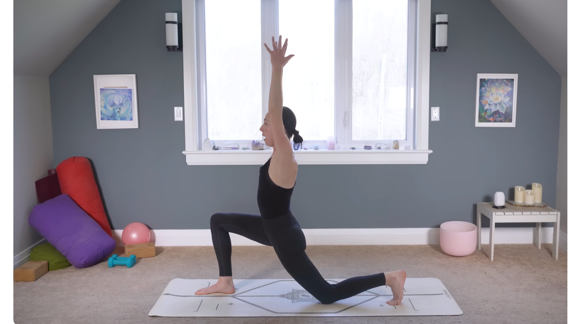 Yoga teacher in a low lunge with her back knee on the mat