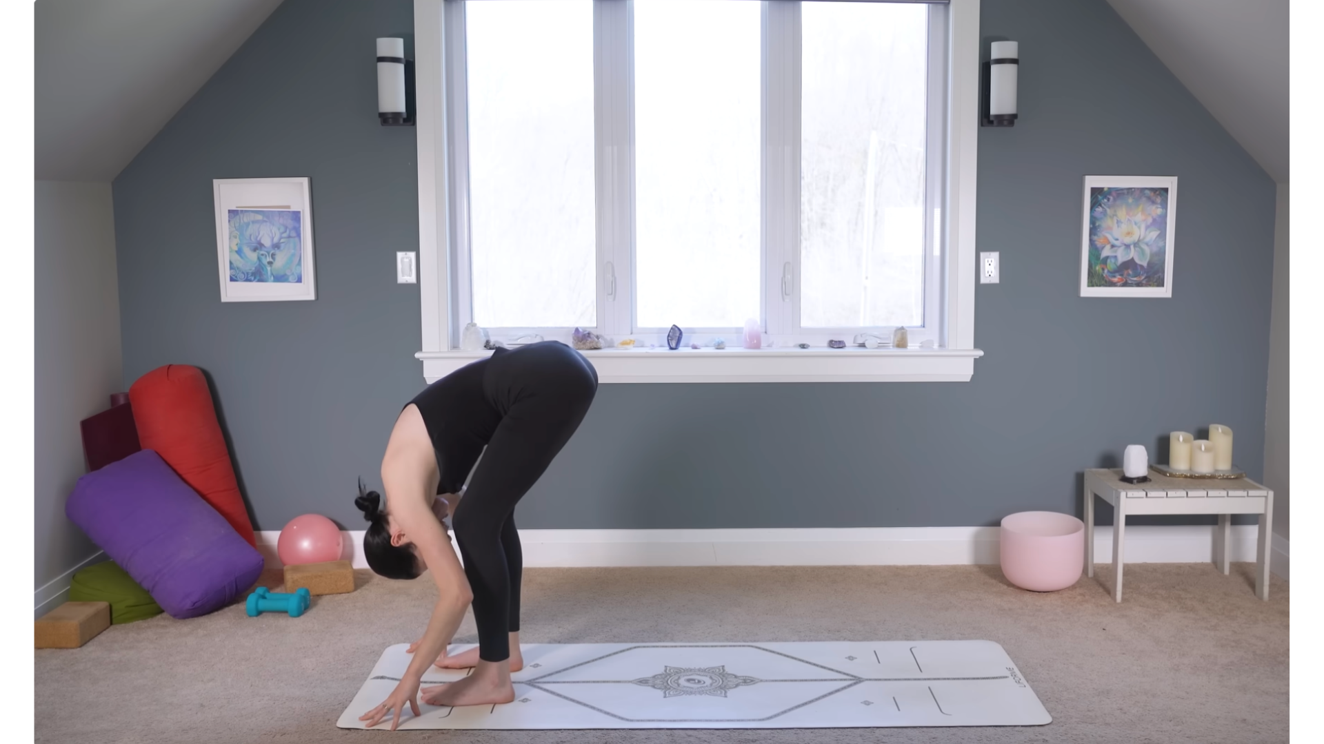 Yoga teacher folding forward while standing during a 10-minute morning yoga routine