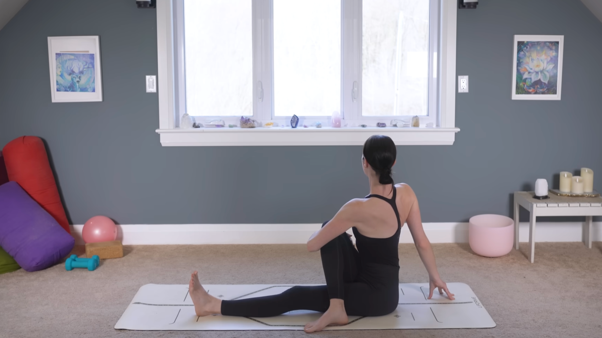 Yoga teacher leading a 10-minute morning yoga class through a seated twist