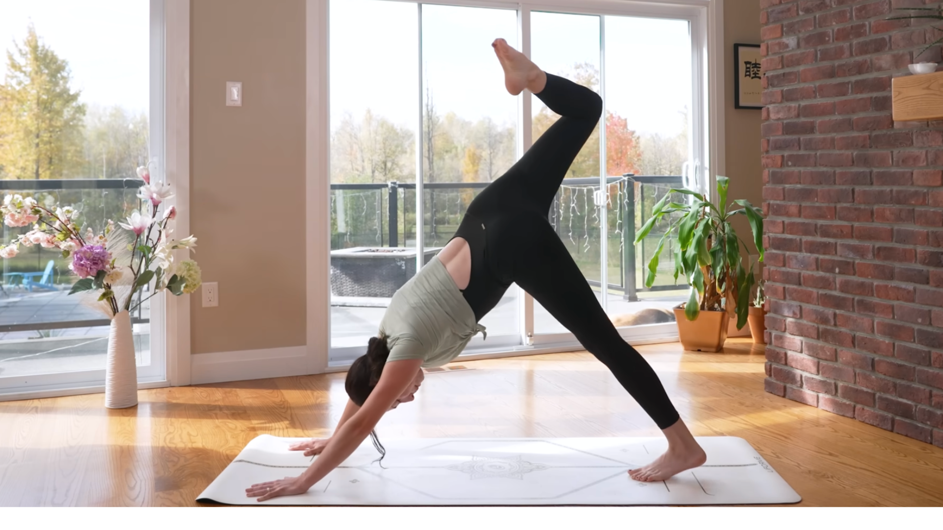 Woman practicing 3-legged dog on a mat