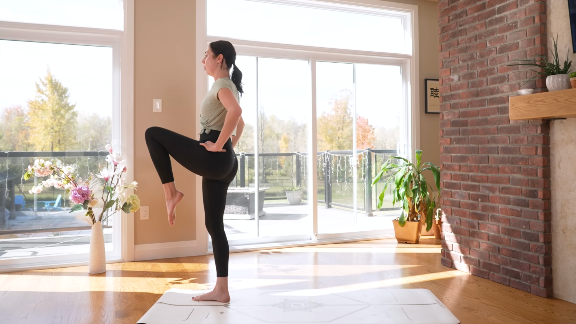 Woman practicing hip-flexor strengthening during a 15-minute morning yoga practice