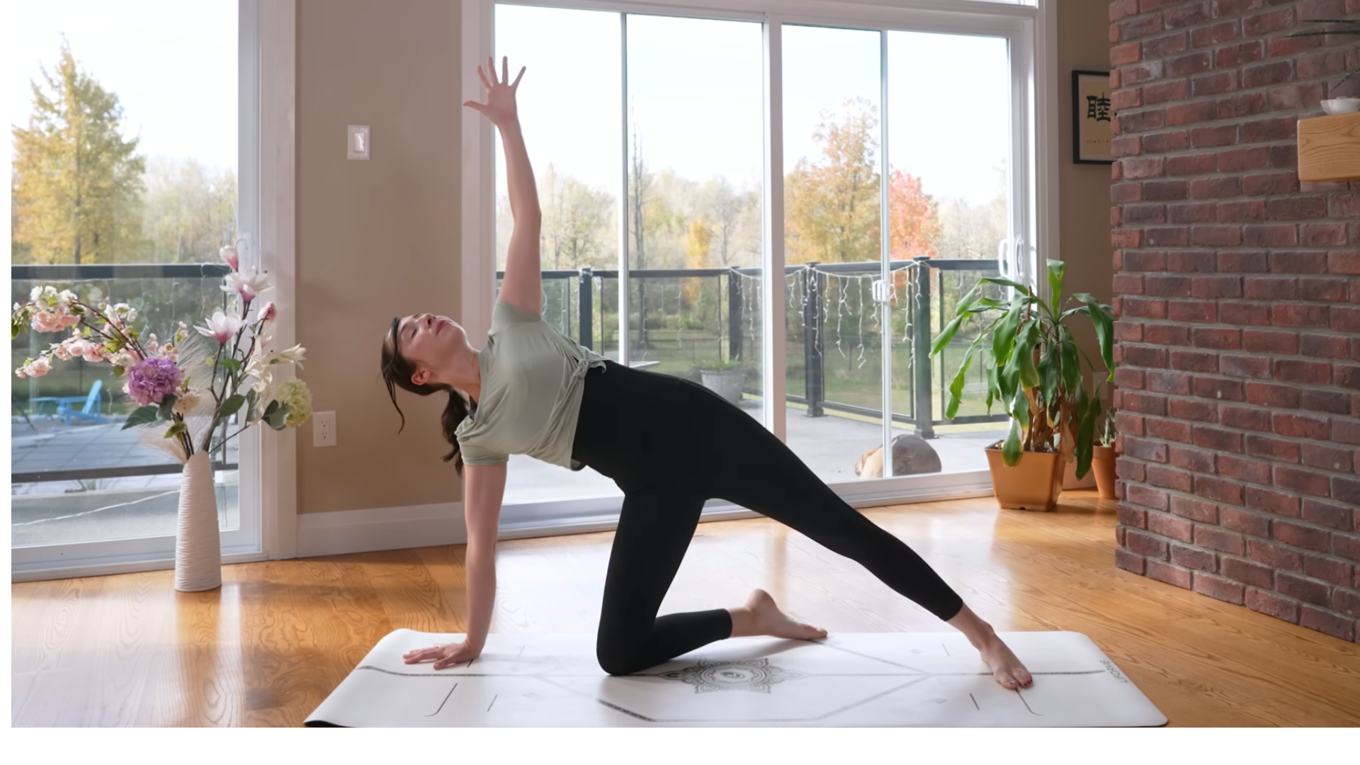 Woman kneeling on a mat in Side Plank