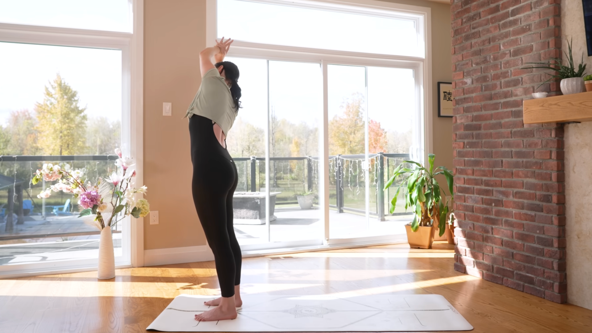 Yoga teacher standing in a variation of Mountain Pose
