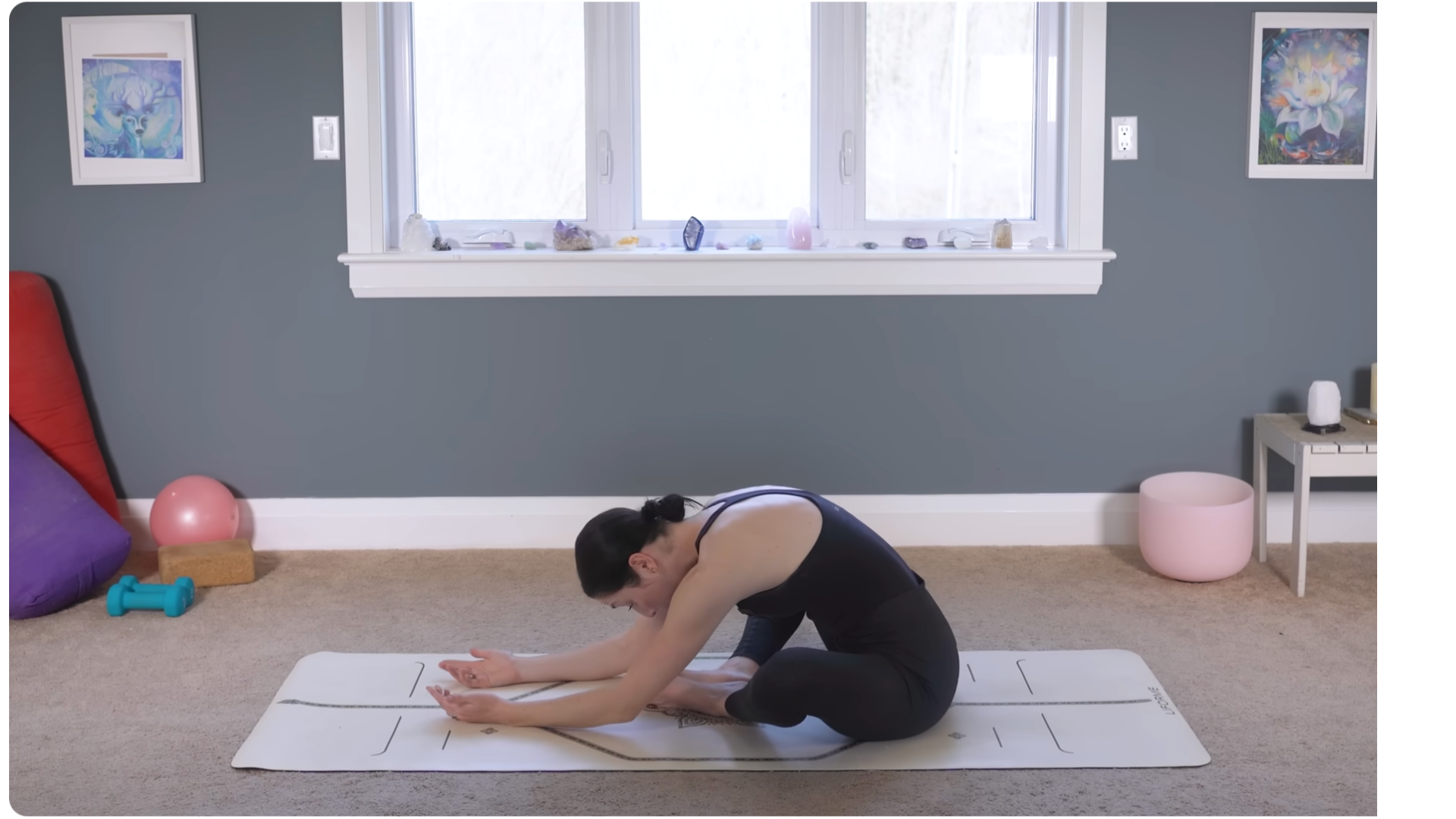 Yoga teacher sitting on a mat in Bound Angle Pose