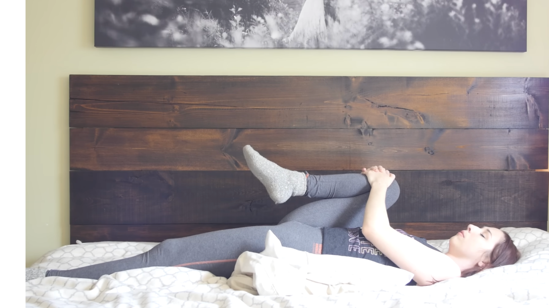 Woman lying on her back on a pillow on bed