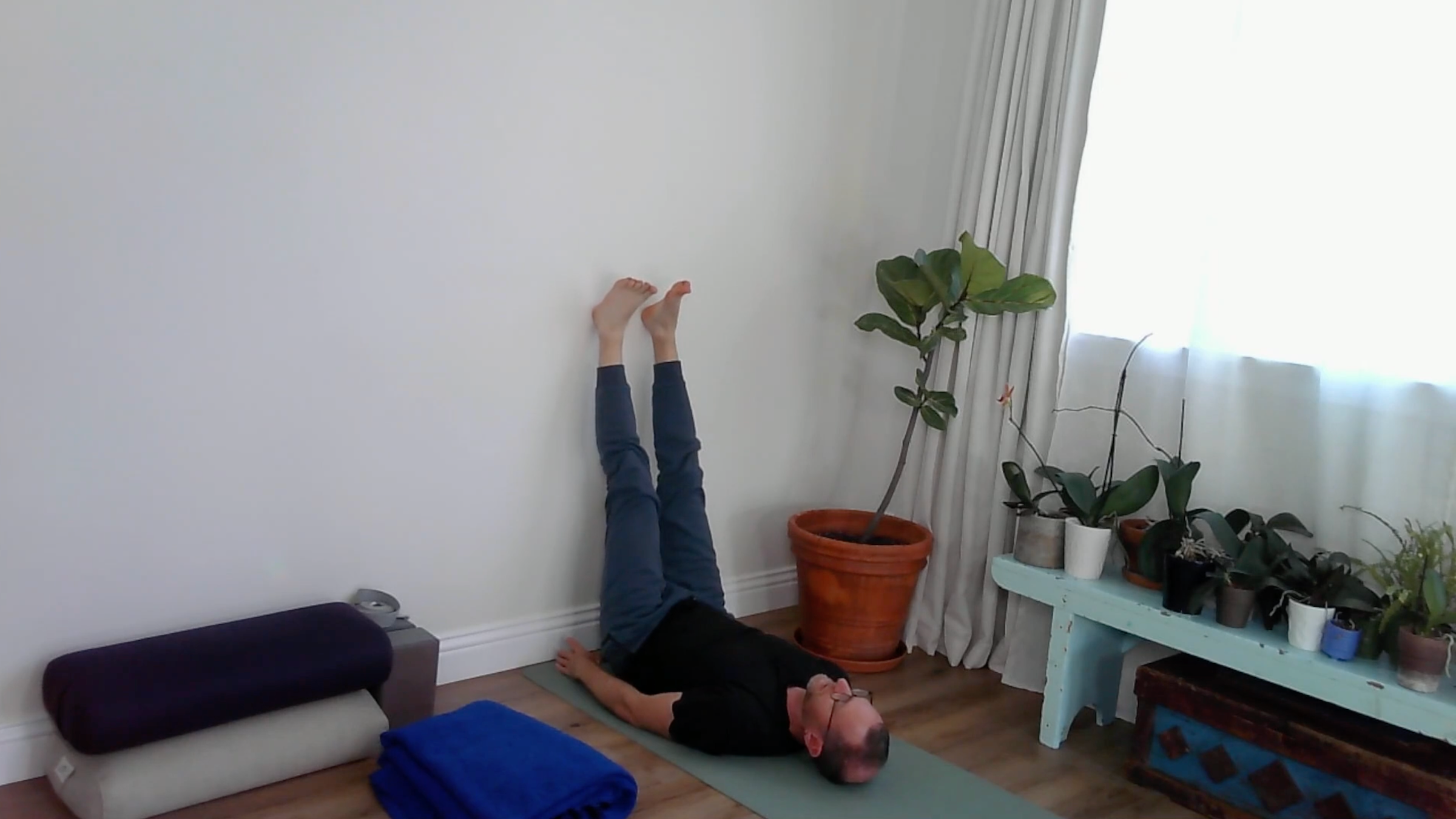 A yoga teacher practicing Legs Up the Wall