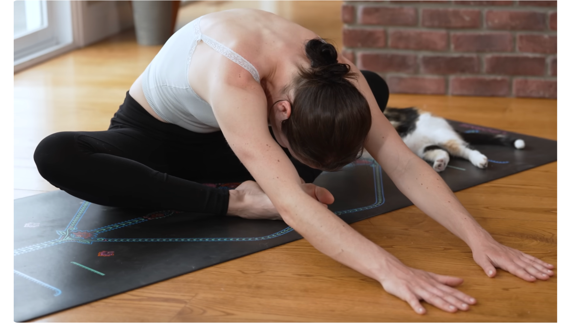 Yoga teacher practicing seated stretches for tight hips