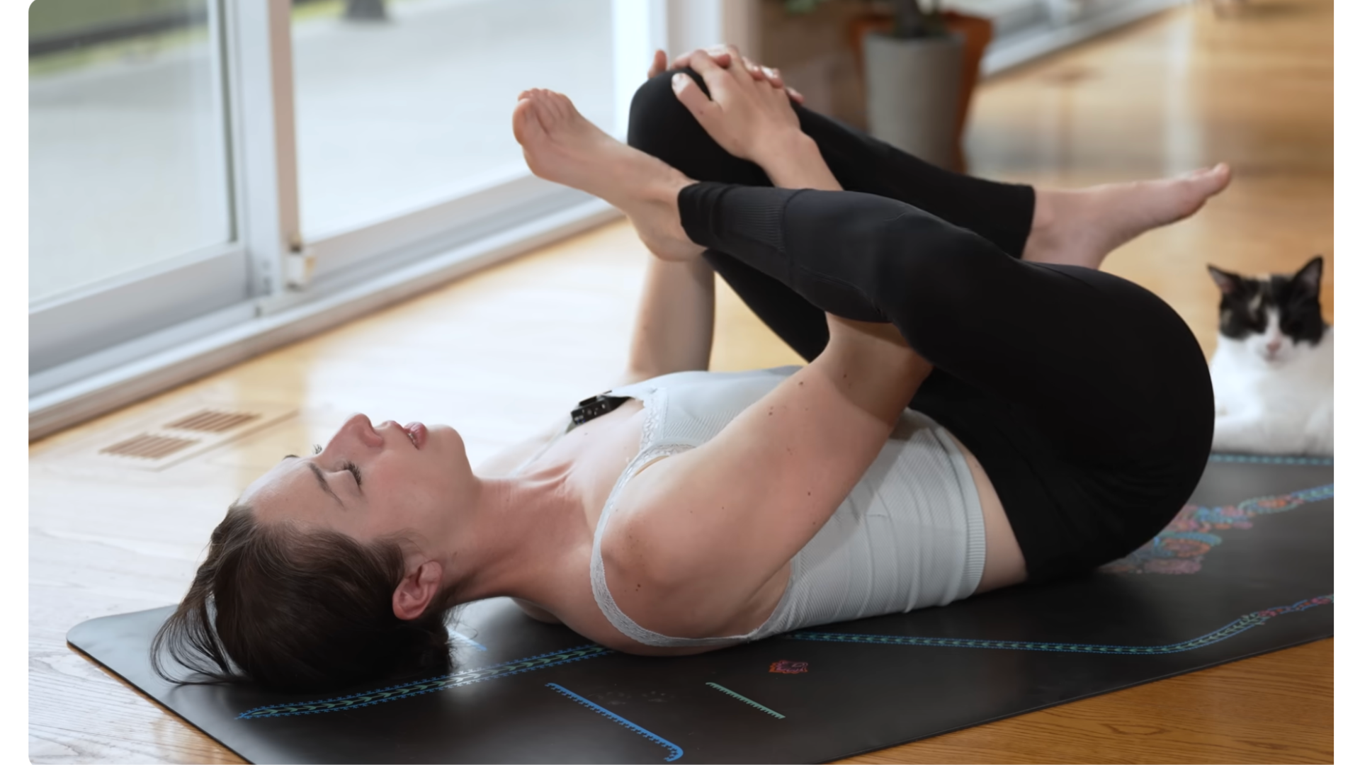 Yoga teacher practicing reclined Figure 4 stretch