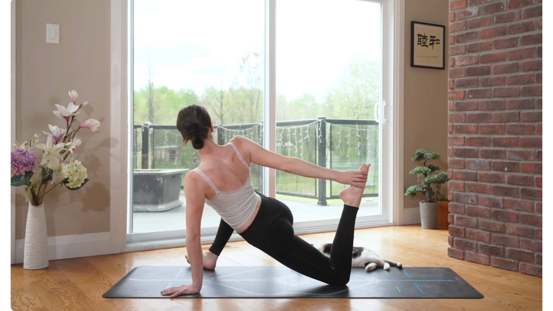 Yoga teacher kneeling on a mat in a hip flexor stretch