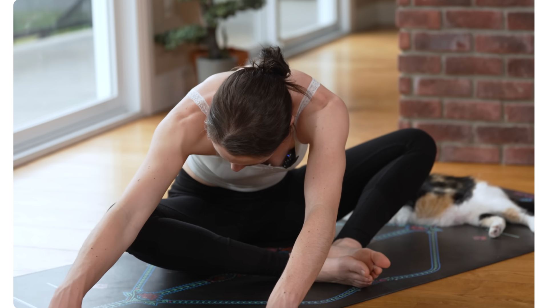 Yoga teacher sitting in Bound Angle Pose leaning to the side in stretches for tight hips