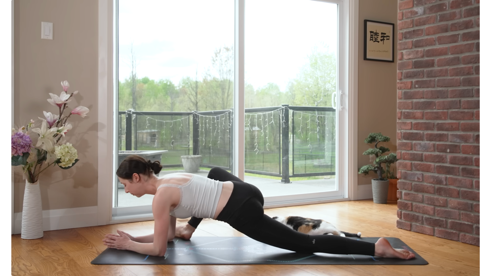 Yoga teacher leaning low to the mat in Lizard Pose