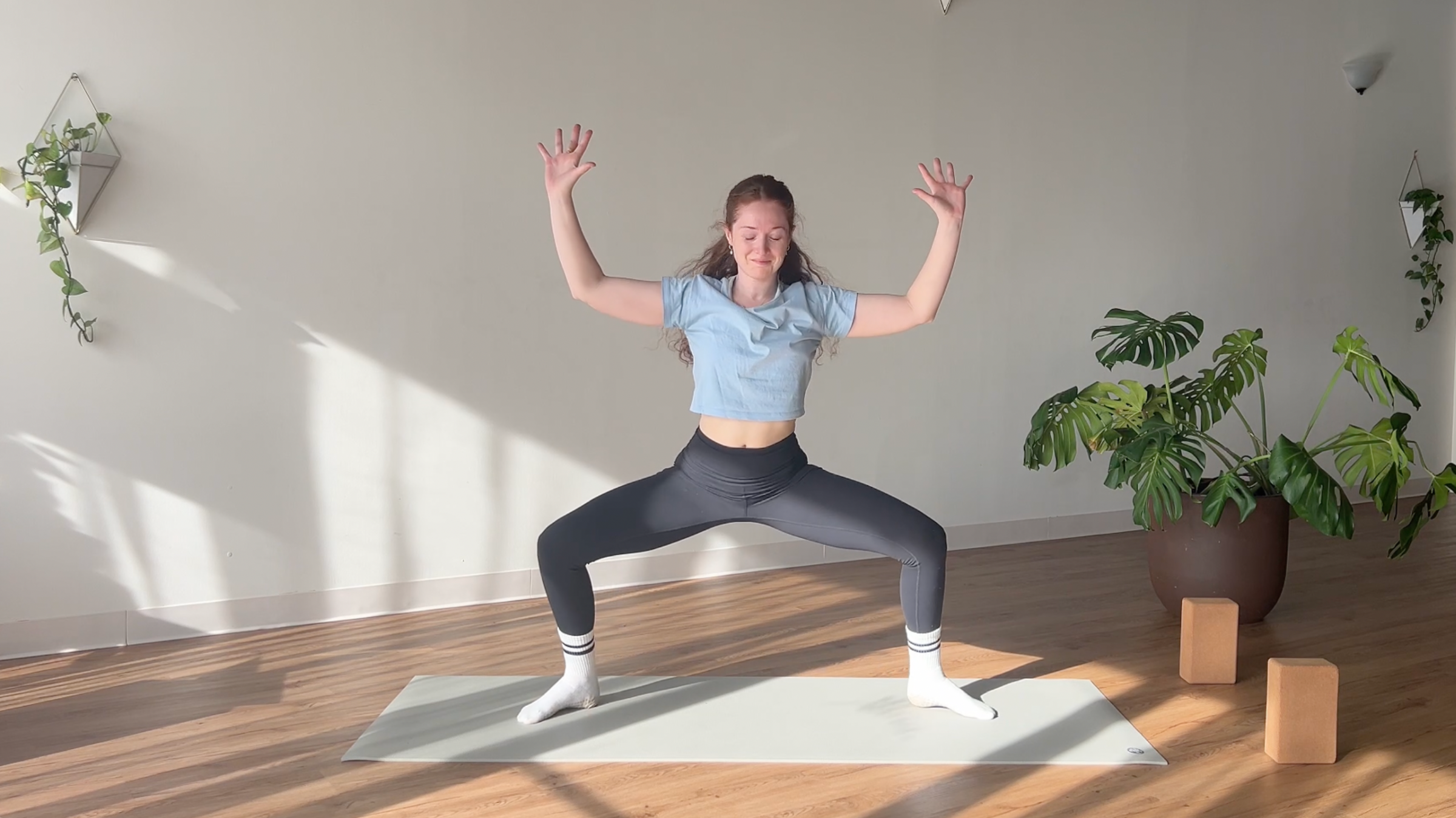 woman in Goddess Pose on yoga mat