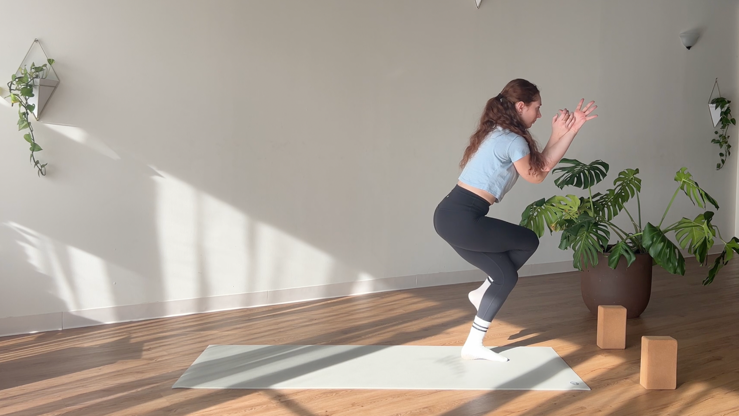woman in Eagle Pose on yoga mat