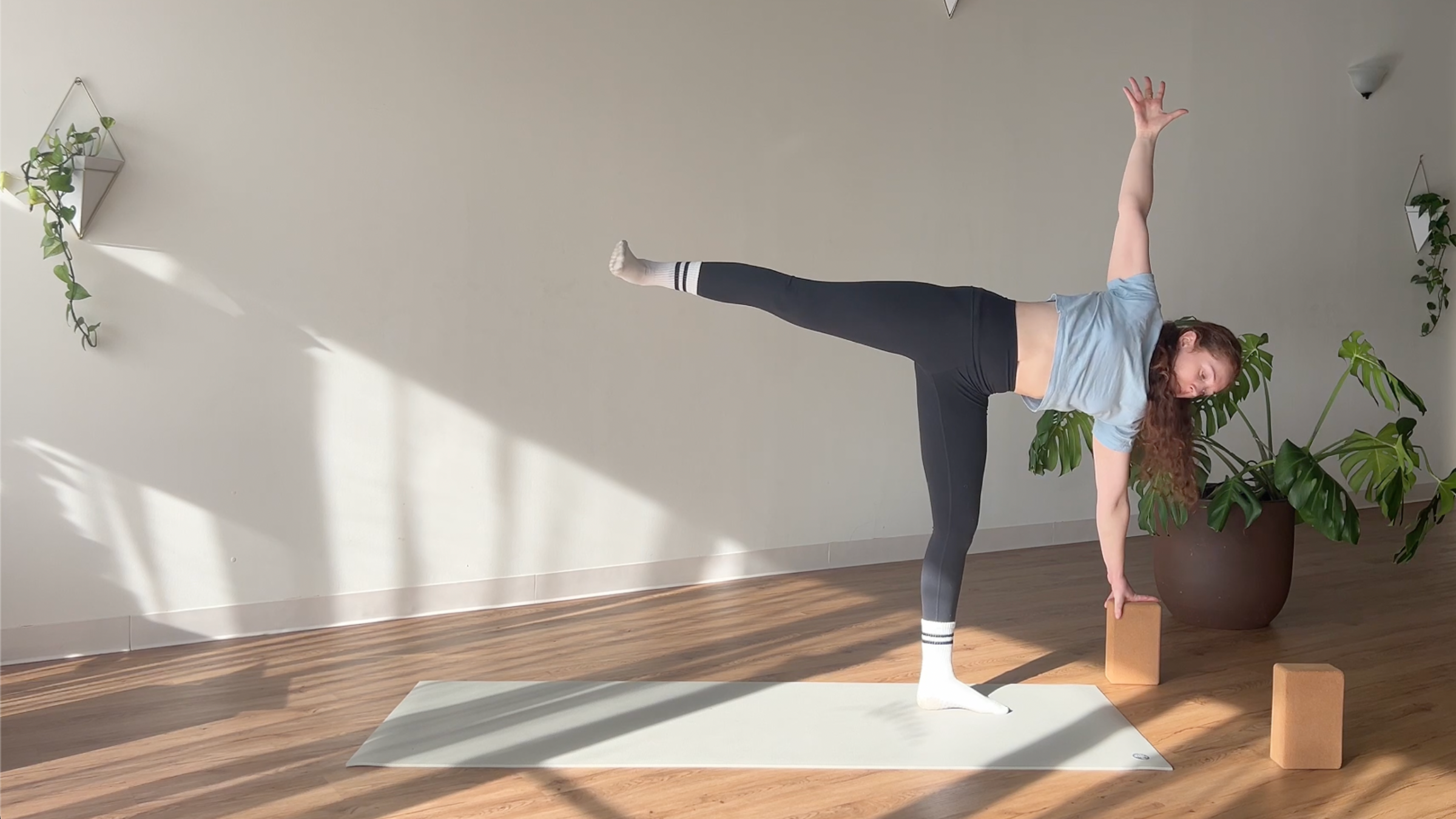 woman in Half Moon pose on yoga mat