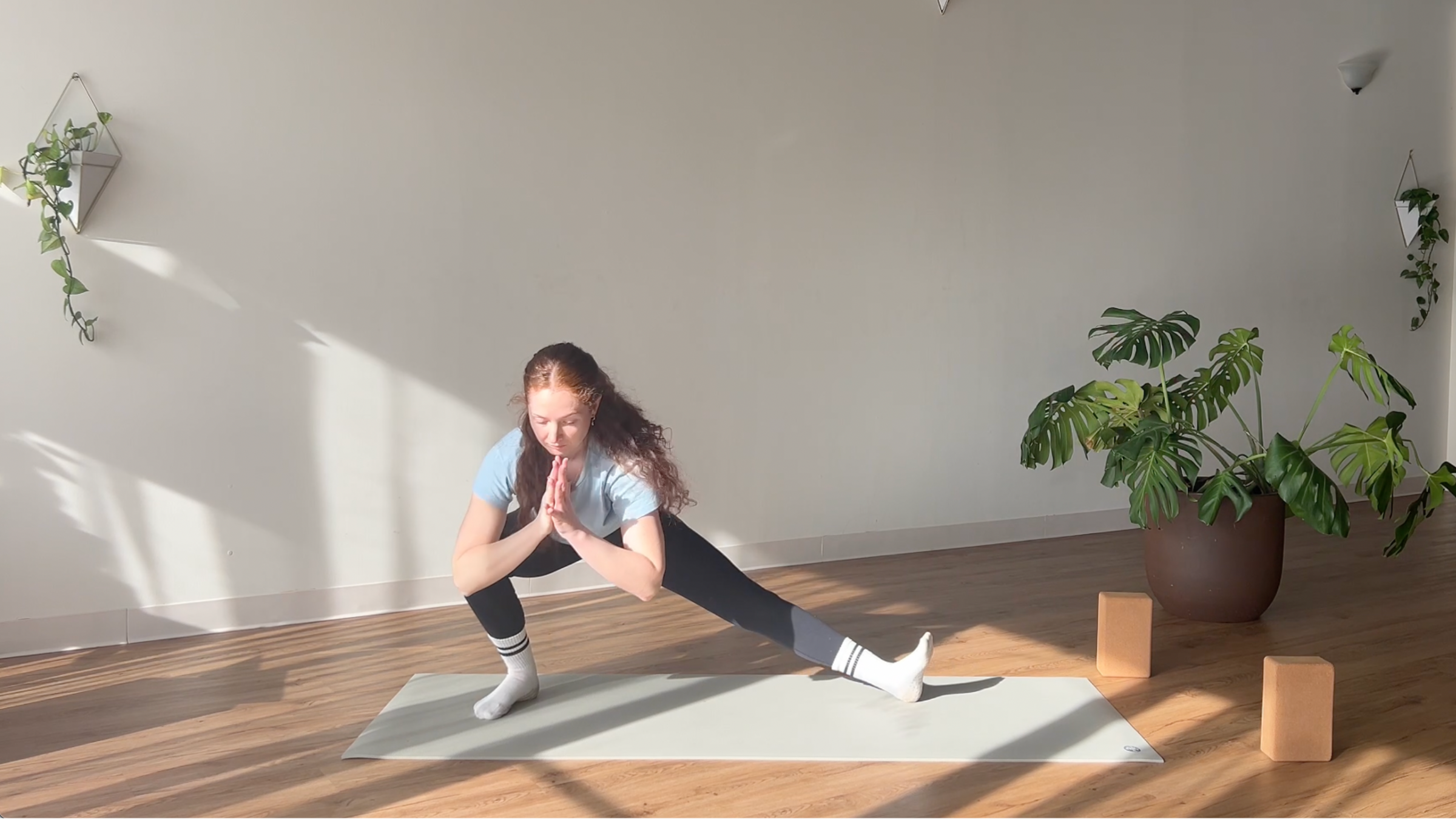 woman in Dancing Side Lunge (Skandasana) pose on yoga mat