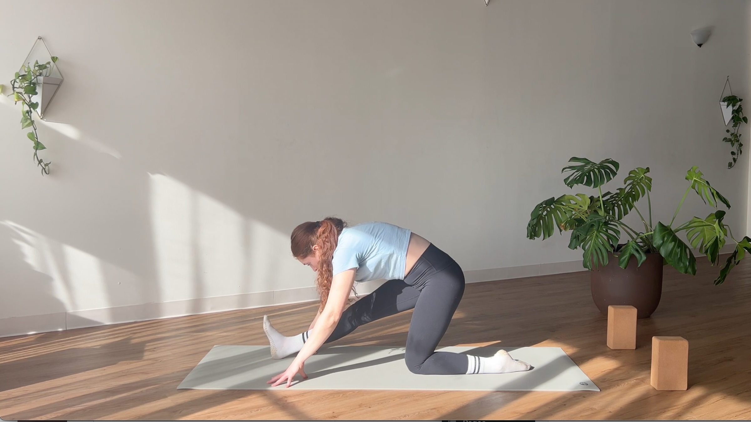 woman in Half Splits pose on yoga mat