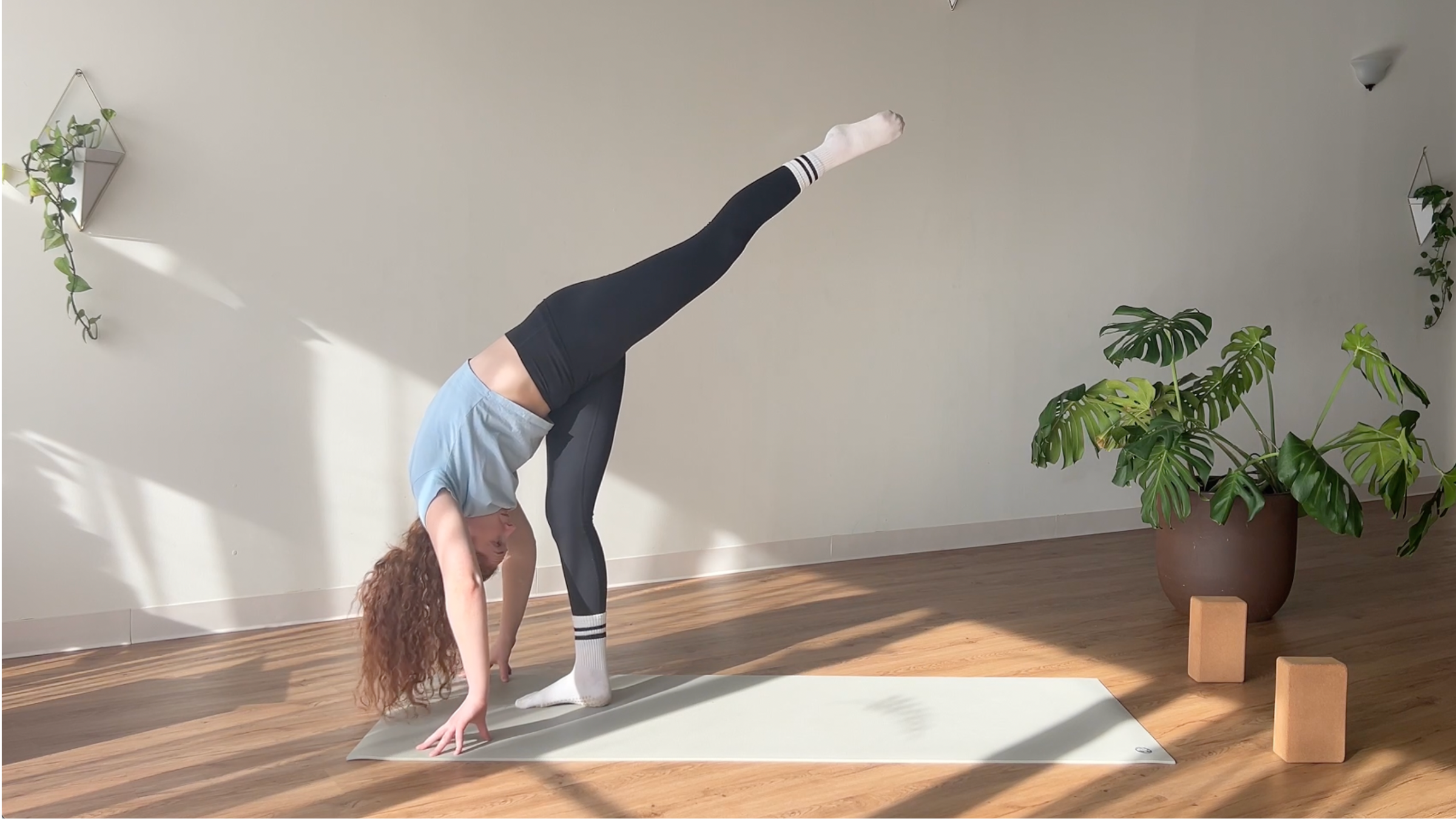 woman in Standing Split pose on yoga mat